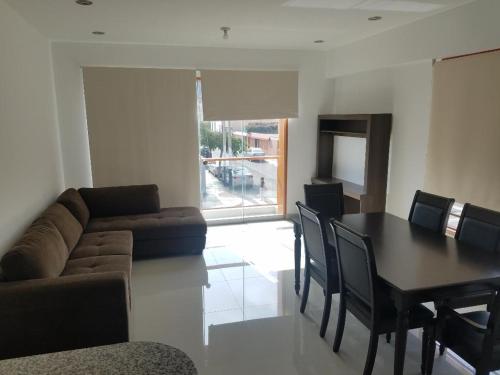 a living room with a table and a couch at Jirón Tarapacá 398, La Punta - Callao in Lima