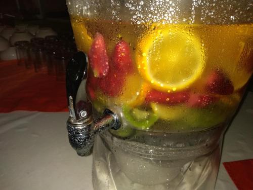 a glass vase with fruit in it on a table at Hotel Playa Azul in Catemaco