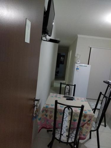 a kitchen with a table and chairs and a television at Flat Avenida - centro -BONITO-PE perto de tudo in Bonito