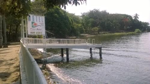 a dock in the middle of a river with a sign at Hotel Playa Azul in Catemaco