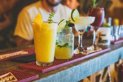 a table with two drinks on a bar at Republica Hostel Santa Marta in Santa Marta