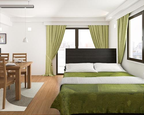 a bedroom with a green bed and a table and a desk at Asakusa HomeSuites Tokyo in Tokyo