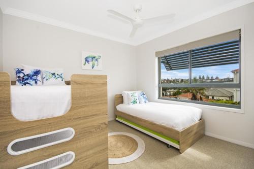 a bedroom with a bed and a window at Breakers 2 12 - LJHooker Yamba in Yamba