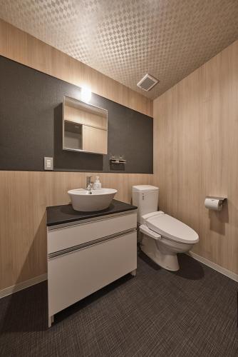 a bathroom with a sink and a toilet at Stay SAKURA Kyoto Matsuri in Kyoto