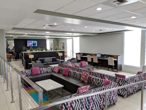 a waiting room with couches and chairs in a lobby at Best Western Plus Commerce Hotel in Los Angeles