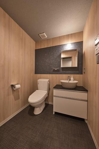 a bathroom with a toilet and a sink at Stay SAKURA Kyoto Matsuri in Kyoto