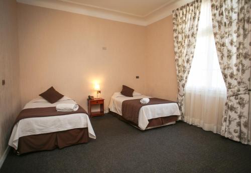 Hotel Plaza Londres 77にあるベッド