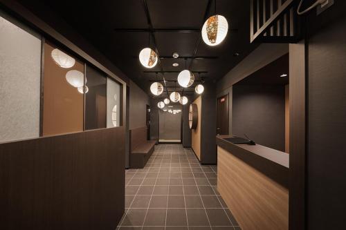 a hallway with many lights and a hallwayasteryasteryasteryasteryasteryasteryasteryastery at Stay SAKURA Kyoto Matsuri in Kyoto