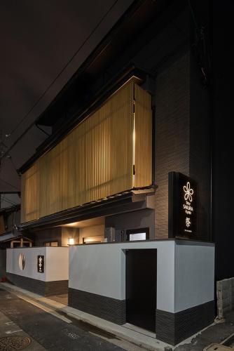 a building with a counter in front of it at night at Stay SAKURA Kyoto Matsuri in Kyoto
