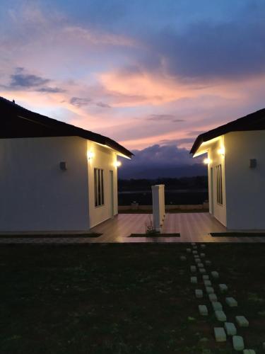 a couple of buildings with lights on them at night at Halcyon Days @ Langkawi in Pantai Cenang
