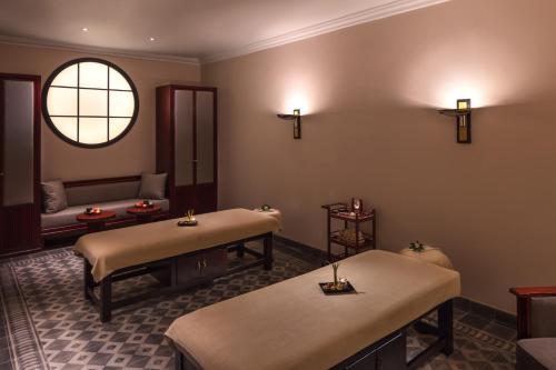 a therapy room with two beds and a window at Azerai La Residence, Hue in Hue