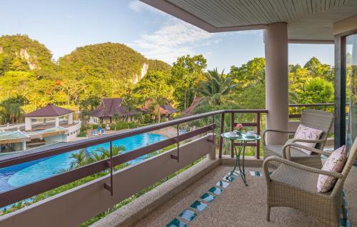 a balcony with a view of the water and mountains at Maritime Park And Spa Resort in Krabi town