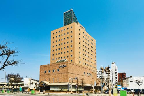 a tall building with a tower on top of it at ART HOTEL Aomori in Aomori