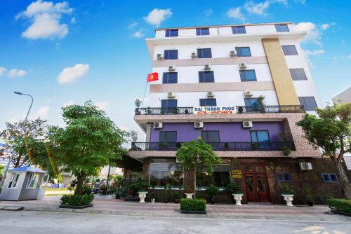 a tall white building with a balcony at ĐẠI THÀNH PHÚC in Hai Phong
