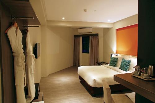 a hotel room with a bed and a desk at PROXY by The Oriental Albay in Legazpi