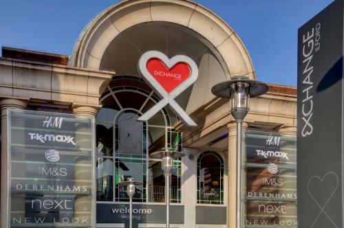 a store front with a heart sign in the window at Best Western Greater London in Ilford