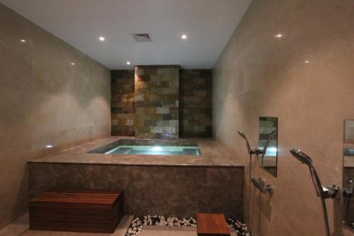 a bathroom with a jacuzzi tub in a room at 85 SOHO Premium Residences in Yangon