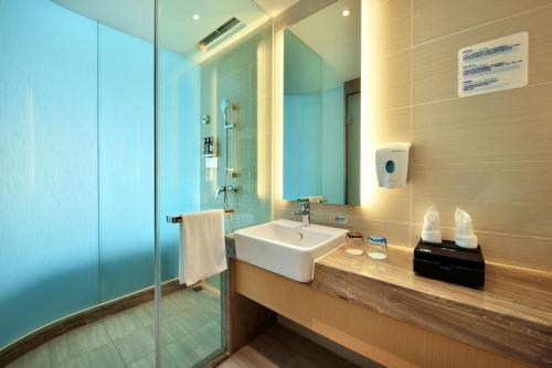 Holiday Inn Express Chengdu Tianhe, an IHG Hotel في Pi: حمام مع حوض ودش زجاجي