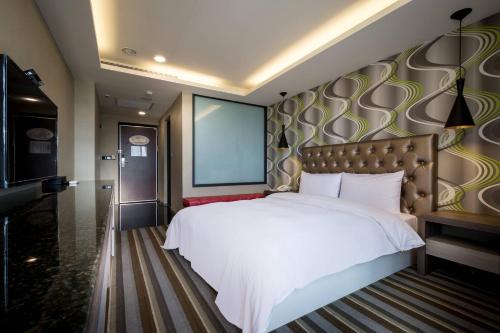 Una cama o camas en una habitación de JUNG-ZAW BUSSINESS HOTEL