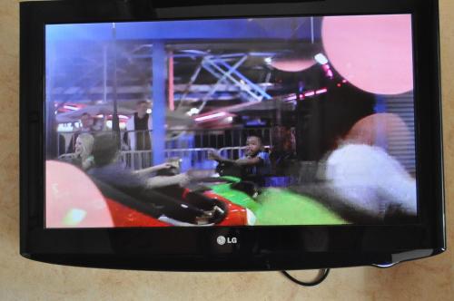 a television screen with people playing a video game at At 9 Motel in Howell