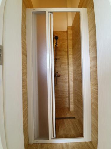 a sliding glass door with a shower in a room at Villa Rolla in Tivat