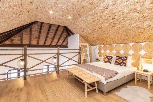 法魯的住宿－FARO DOWNTOWN STUDIOS，一间卧室设有一张床和木制天花板
