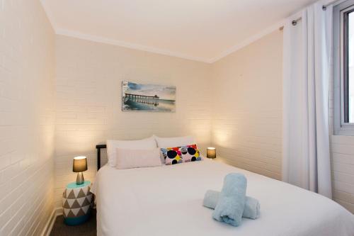 a bedroom with a white bed and a window at Stay Okay Central - Fremantle in Fremantle