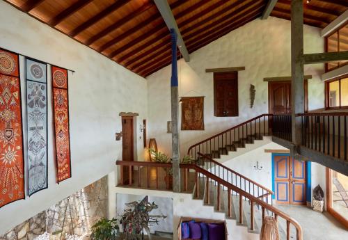 an indoor staircase in a house with wooden ceilings at Bamboo Villa Kandy in Digana