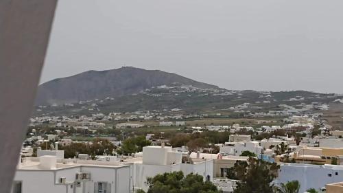 a view of a city with a mountain in the background at Firaxenia rooms in Fira