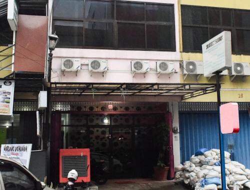 a building with a door with speakers on it at RedDoorz at Pettarani Square Makassar in Makassar