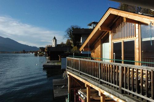 a building on a dock next to a body of water at Hotel Zimmerbräu in St. Wolfgang