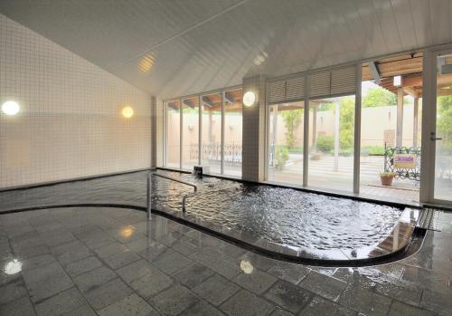 a swimming pool in the middle of a building at Kinta no sato in Hamada