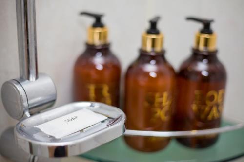 three bottles of sauce sitting on a shelf at Hyundai Elliot Hotel and Resort in Pyeongchang 