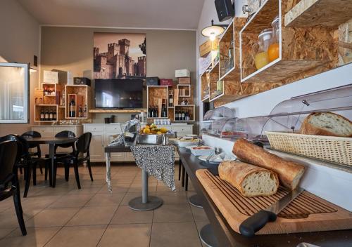 a bakery with bread on a table in a room at Villaggio Turistico Lugana Marina in Sirmione