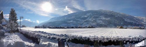 a mountain covered in snow with a snow covered field at FEWO "Unterm Wald" in Stumm