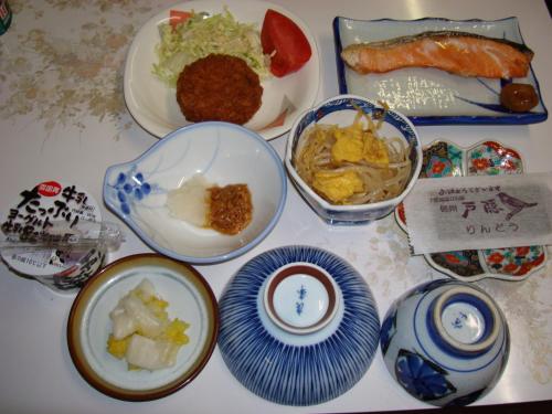 a table topped with plates and bowls of food at Togakushi- Kogen Minshuku Rindo in Nagano