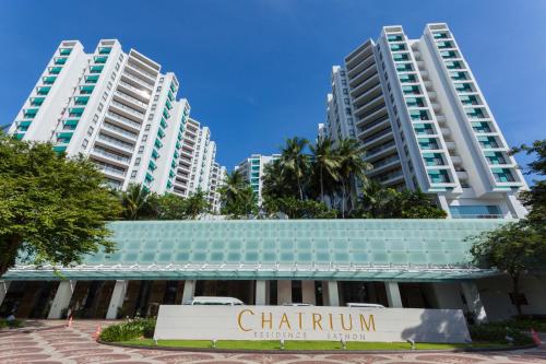 a building in front of two tall buildings at Chatrium Sathon Bangkok in Bangkok