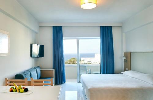 a hotel room with a bed and a view of the ocean at Sunrise Oasis Hotel & Waterpark in Protaras