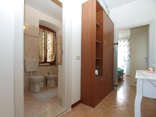 a bathroom with a toilet and a sink at Apartment Mile 1872 in Fažana