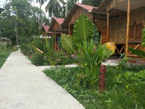 a house with a path in front of a garden at Havelock Farms Resort in Havelock Island
