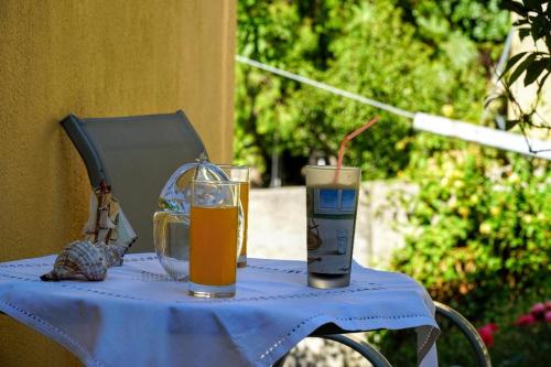two glasses of orange juice sitting on a table at Agnanti house in Symi