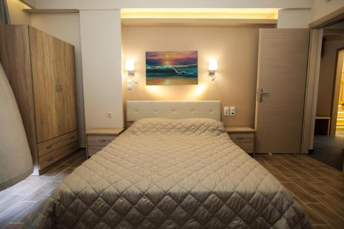 a bedroom with a bed and two night stands at Vista Del Mare Rooms in Nafplio