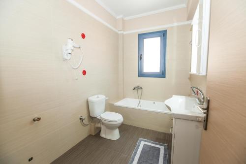 a bathroom with a toilet and a sink at Vista Del Mare Rooms in Nafplio