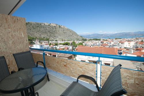 a balcony with a table and chairs and a view at Vista Del Mare Rooms in Nafplio