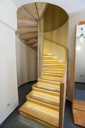 a staircase in a room with wooden steps at Vista Del Mare Rooms in Nafplio