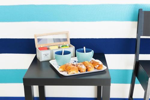a tray of croissants and cups on a table at Boutique Suites in Piazzetta in Capri