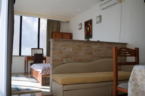 a living room with a couch and some windows at Apartments Basha 1 - Long Beach in Ulcinj