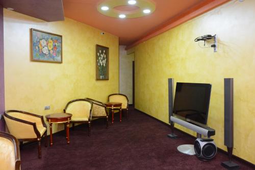 a waiting room with chairs and a flat screen tv at HOTEL N1 in Yerevan