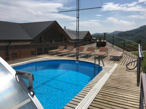 a deck with a swimming pool on top of a house at Dachna Sadyba PB in Migovo