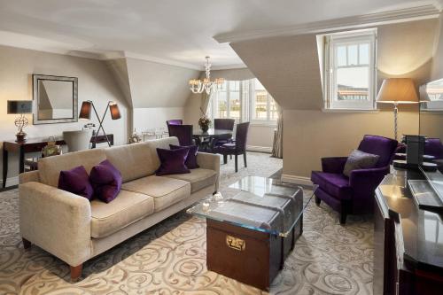 a living room with a couch and purple furniture at The Landmark London in London